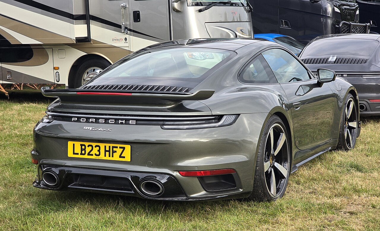 2026 Porsche 911 Turbo S rear three-quarter, wide stance, enlarged side intakes