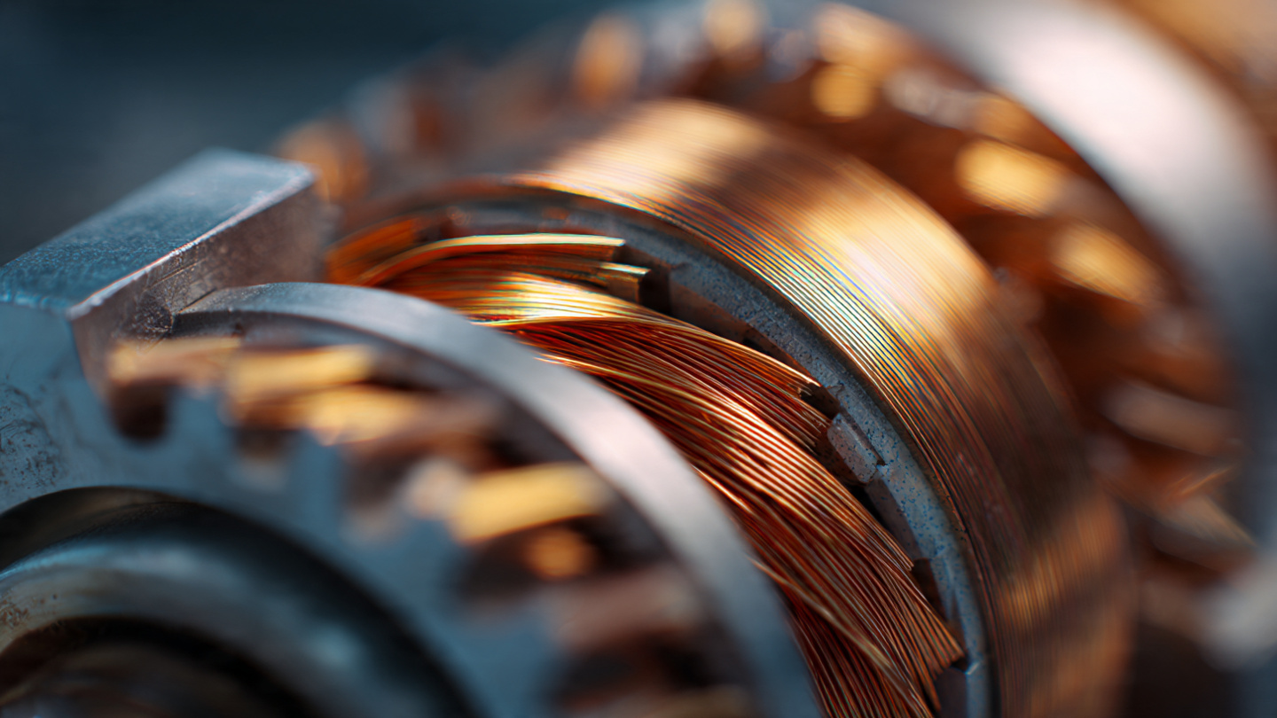 Close-up of Ferrari Luce four-motor electric powertrain components with warm editorial lighting