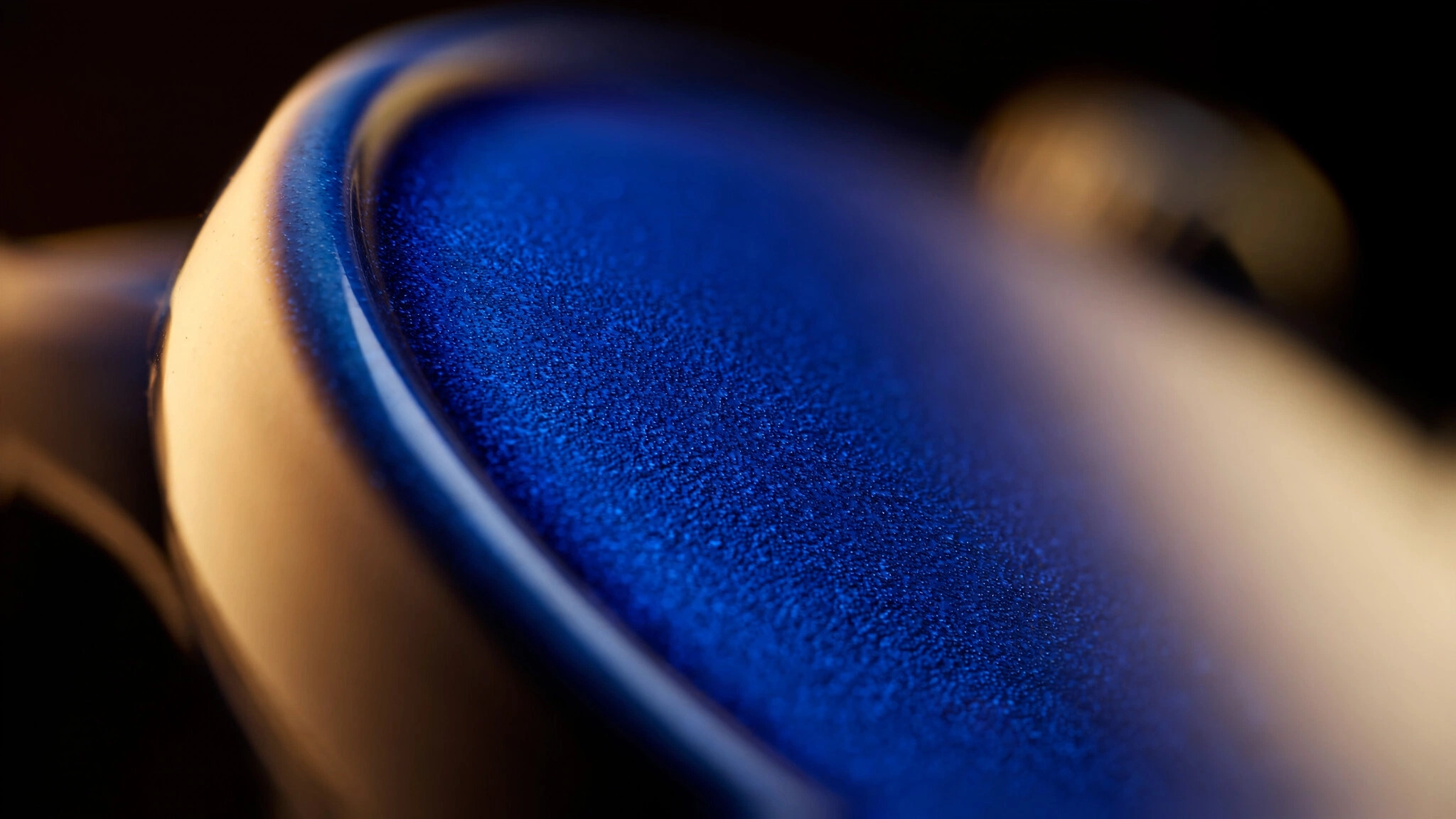 Macro photograph of a vivid blue Hublot ceramic watch case surface showing the dense, scratch-resistant finish achieved through Spark Plasma Sintering