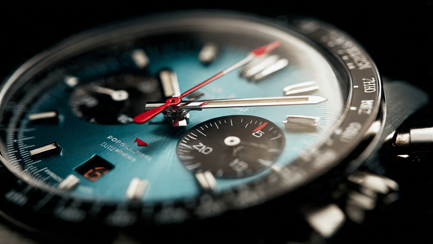 Close-up of the H. Moser Endeavour Flyback Chronograph Dual Time Date turquoise fum&eacute; dial with central chronograph hands and Blackor fum&eacute; central disc